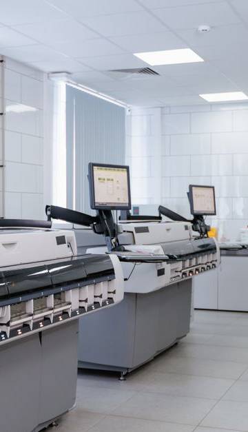 Bright and sterile laboratory featuring high-tech research equipment and professionals at work.