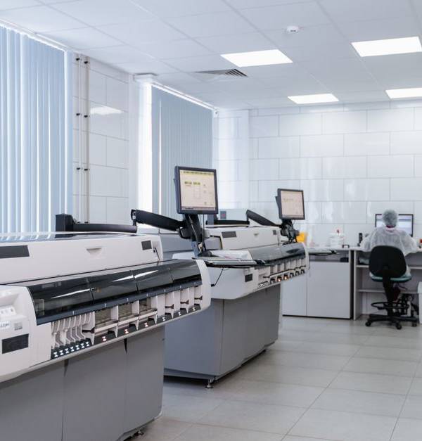 Bright and sterile laboratory featuring high-tech research equipment and professionals at work.
