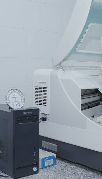 High-tech laboratory equipment with computer system in lab setting.