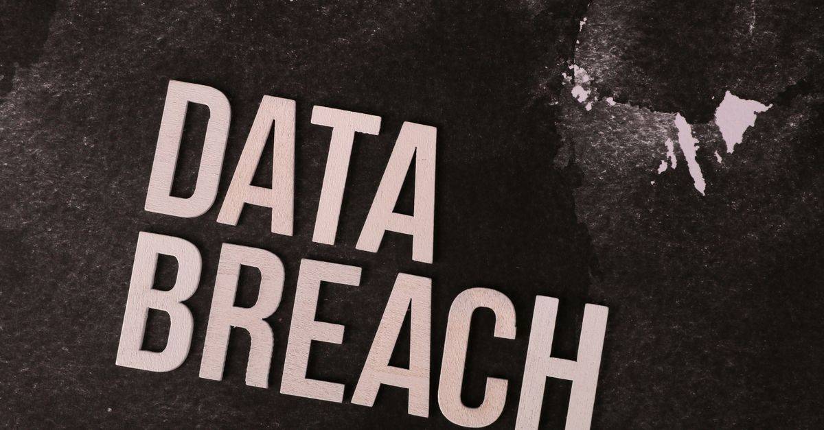 A conceptual image highlighting the issue of data breaches, featuring bold text on a textured background.