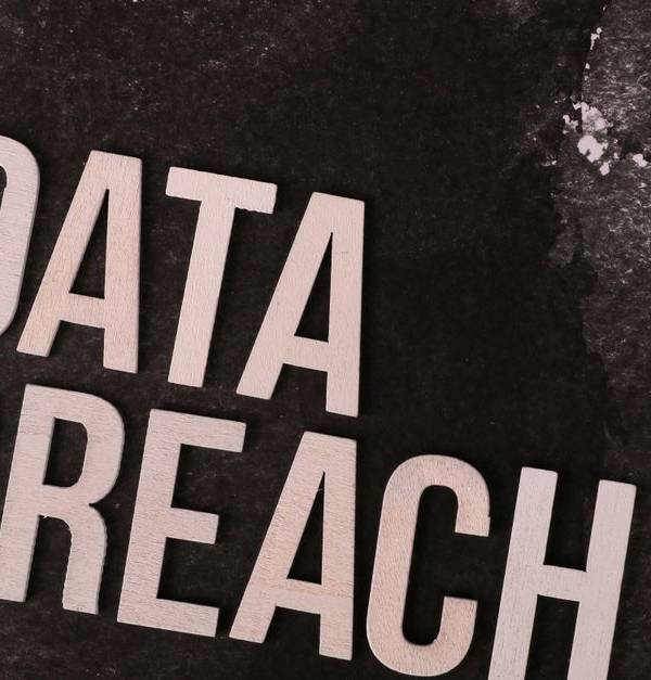A conceptual image highlighting the issue of data breaches, featuring bold text on a textured background.