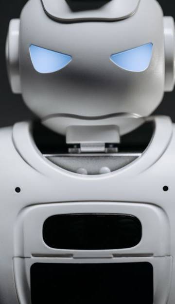 Detailed studio shot of a modern robotic toy with a dark background, showcasing technological design.